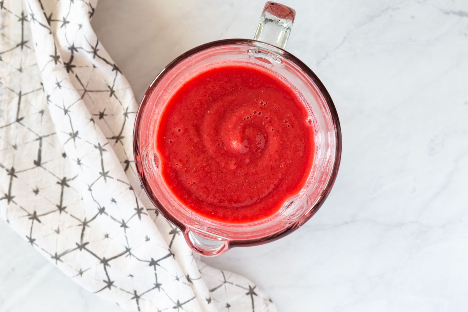 Strawberry smoothie blended until smooth in a blender