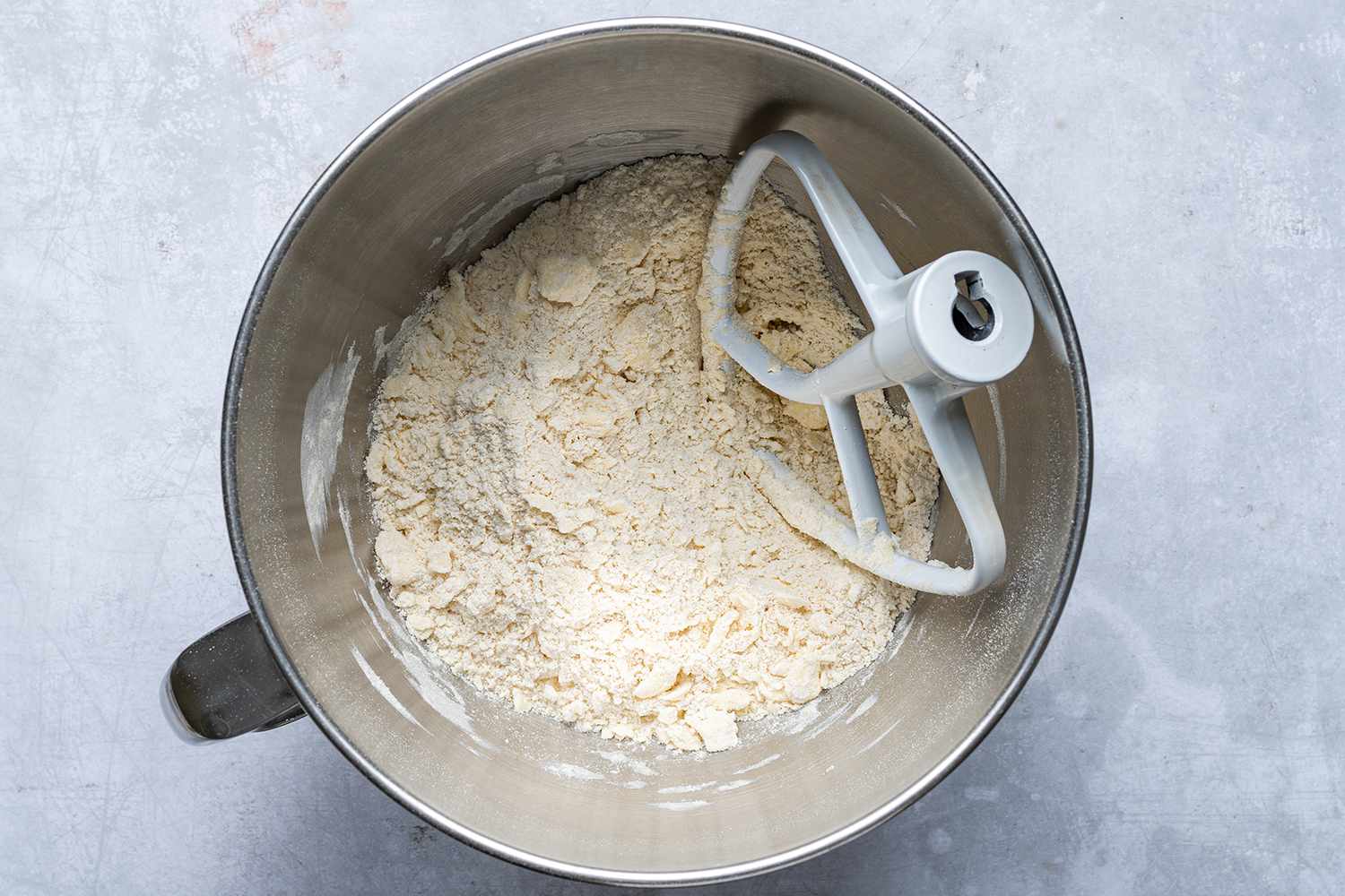 flour with butter crumbs in stand mixer bowl