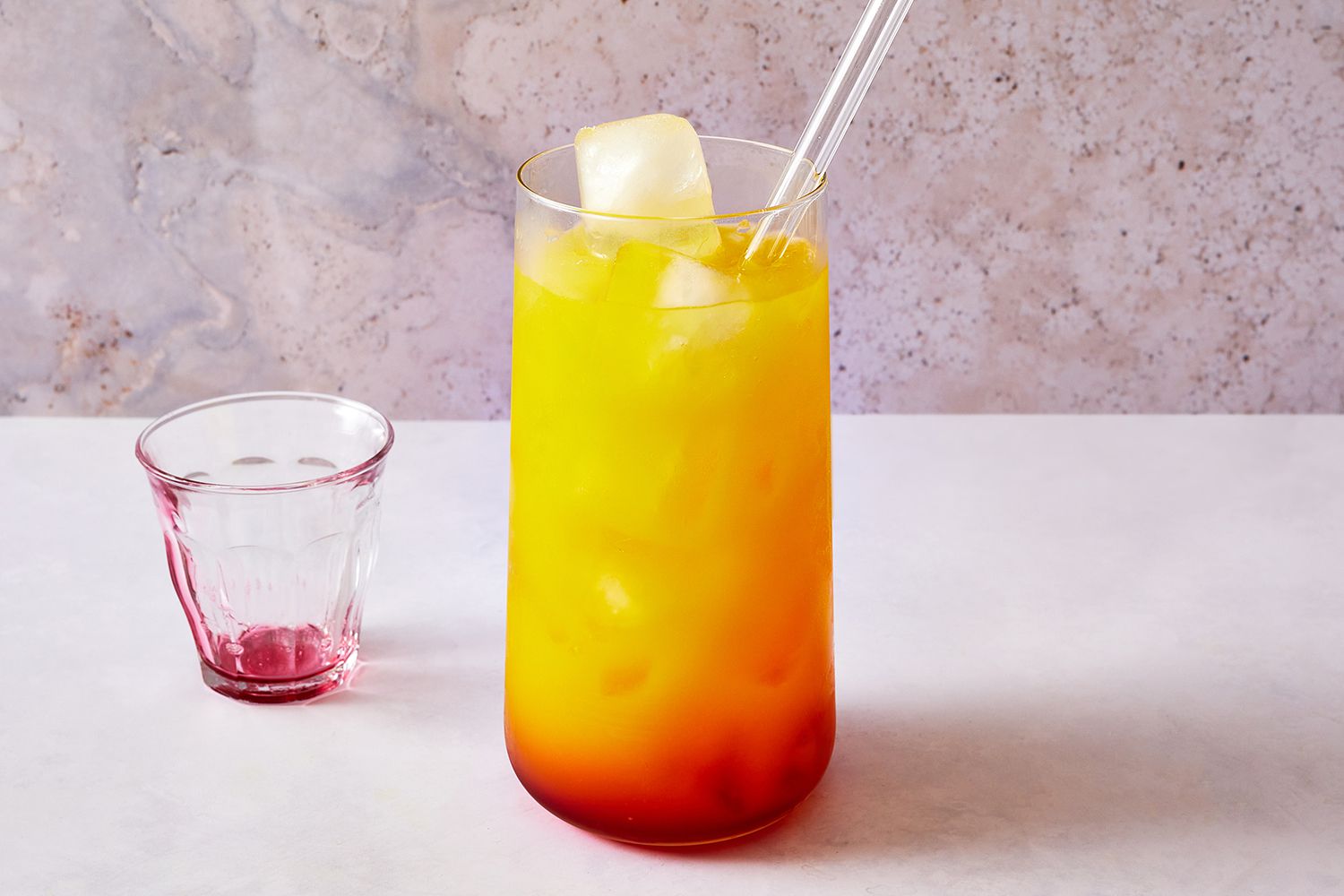 A high ball glass with orange juice, tequila, and grenadine 