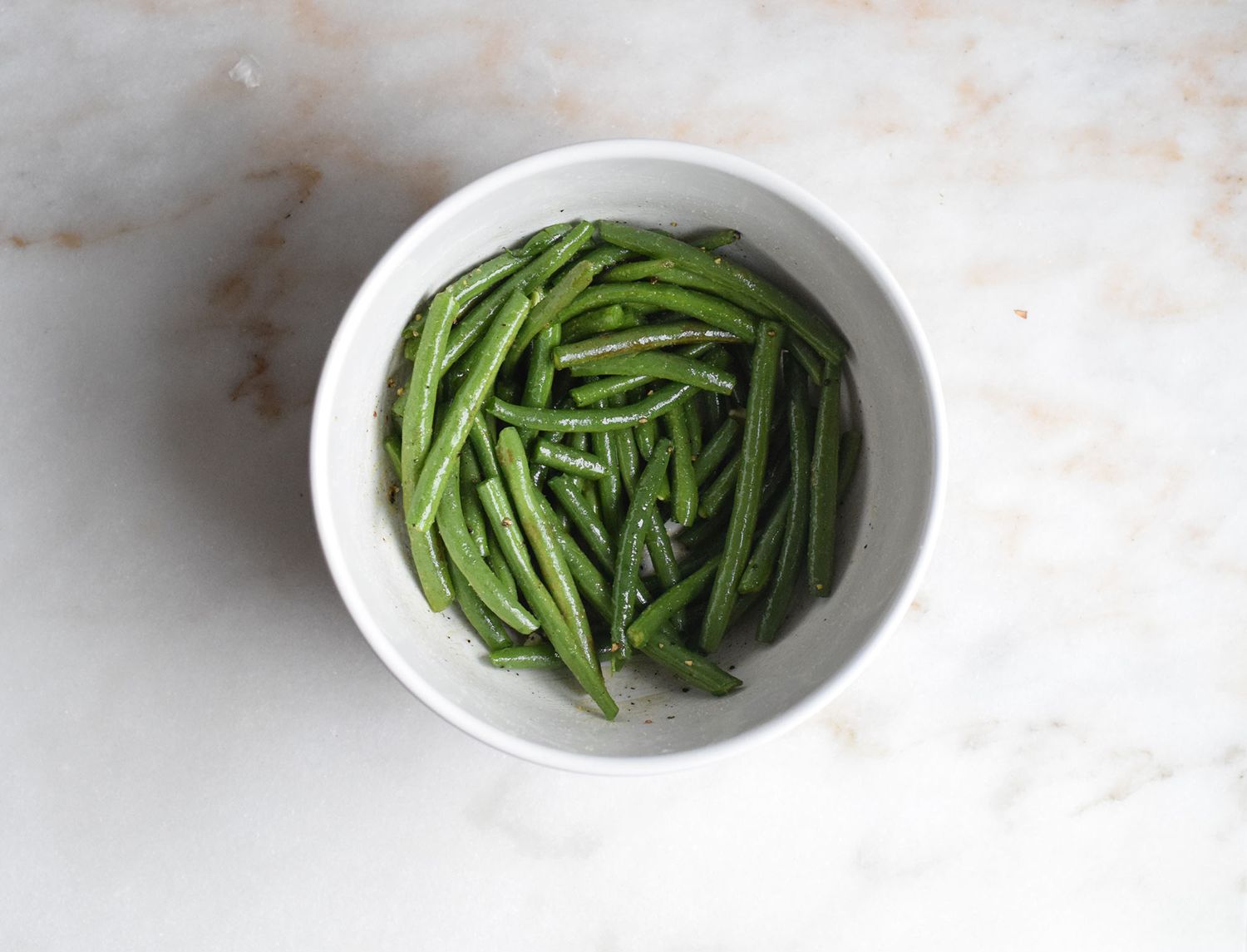 green beans in a bowl with oil