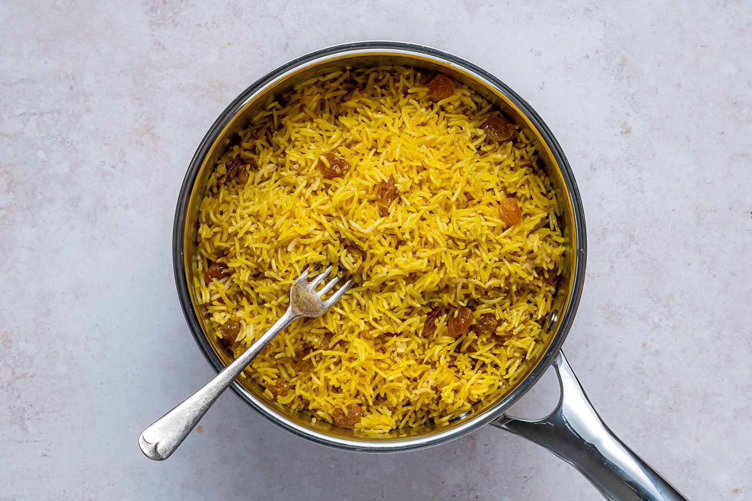 Turmeric Rice in a pot with a fork 