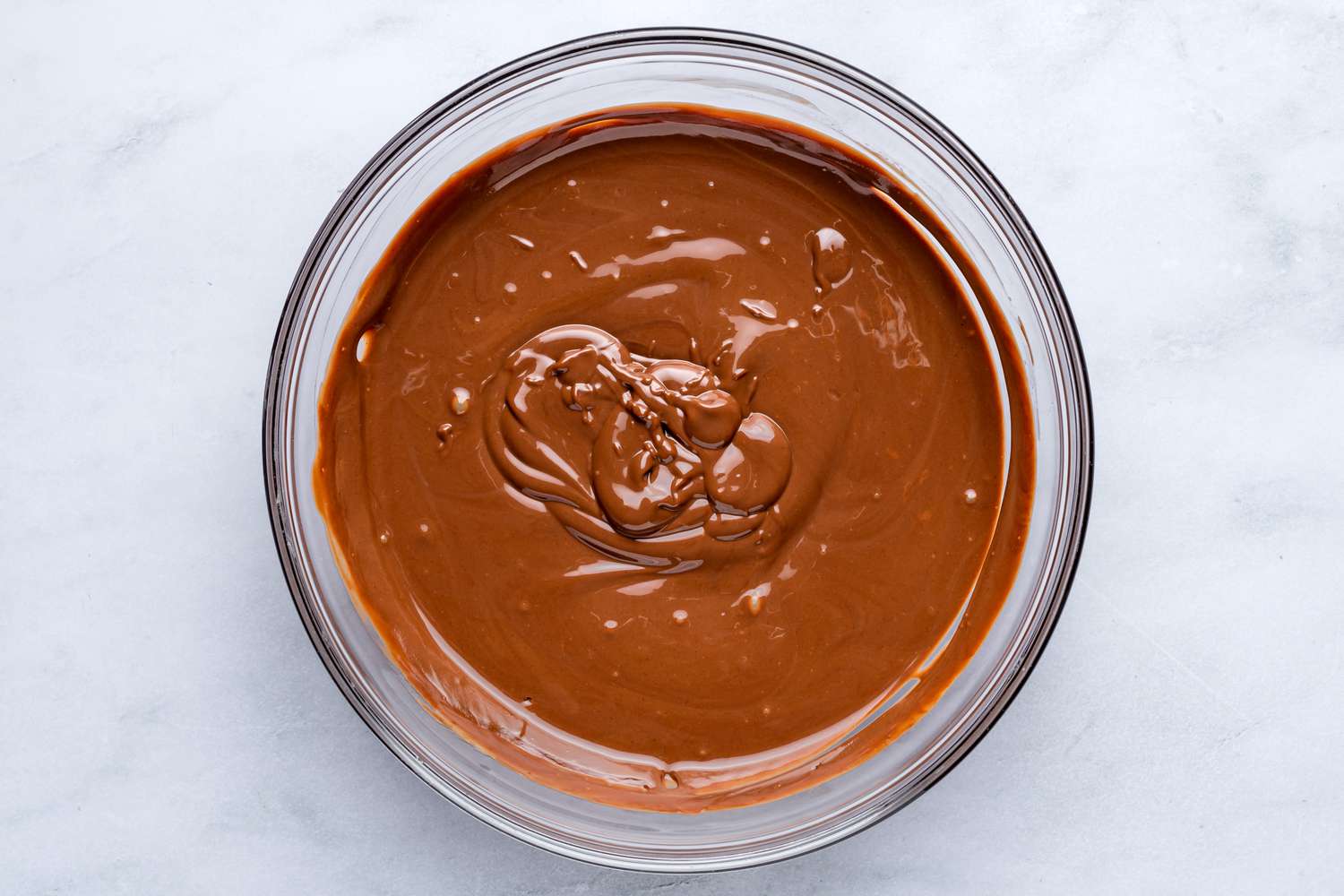 A bowl of melted chocolate, peanut butter, and butter