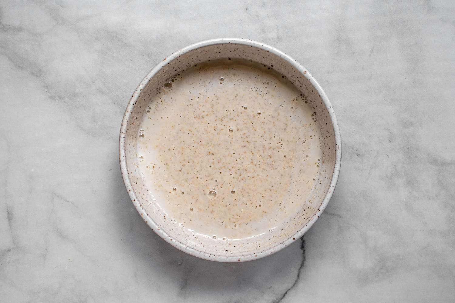 milk and sourdough starter in a bowl