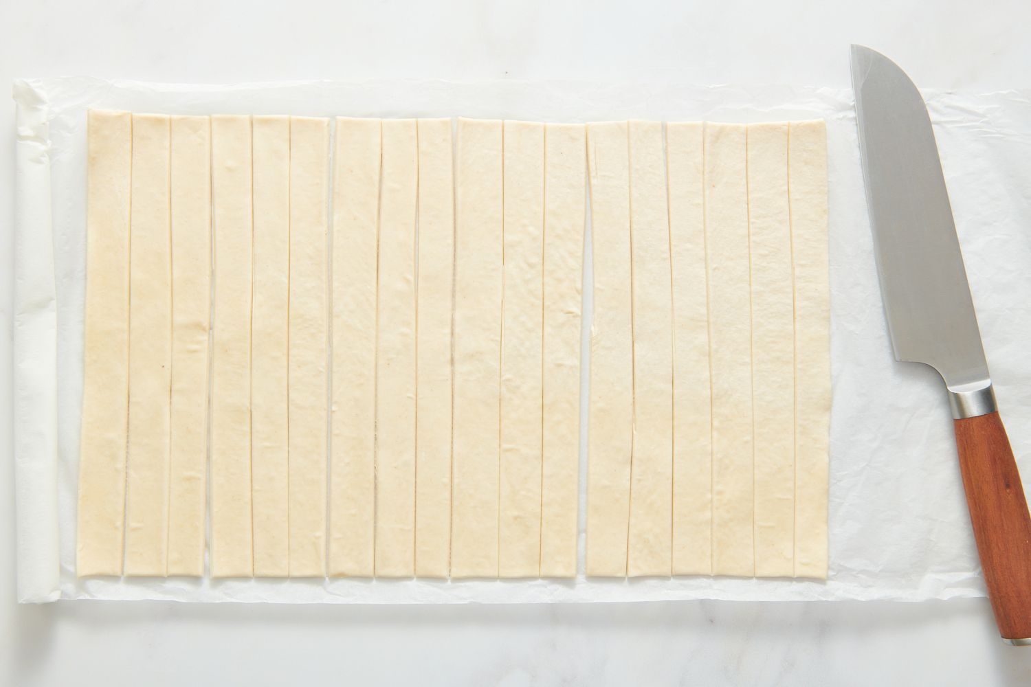A sheet of puff pastry cut into thin slices