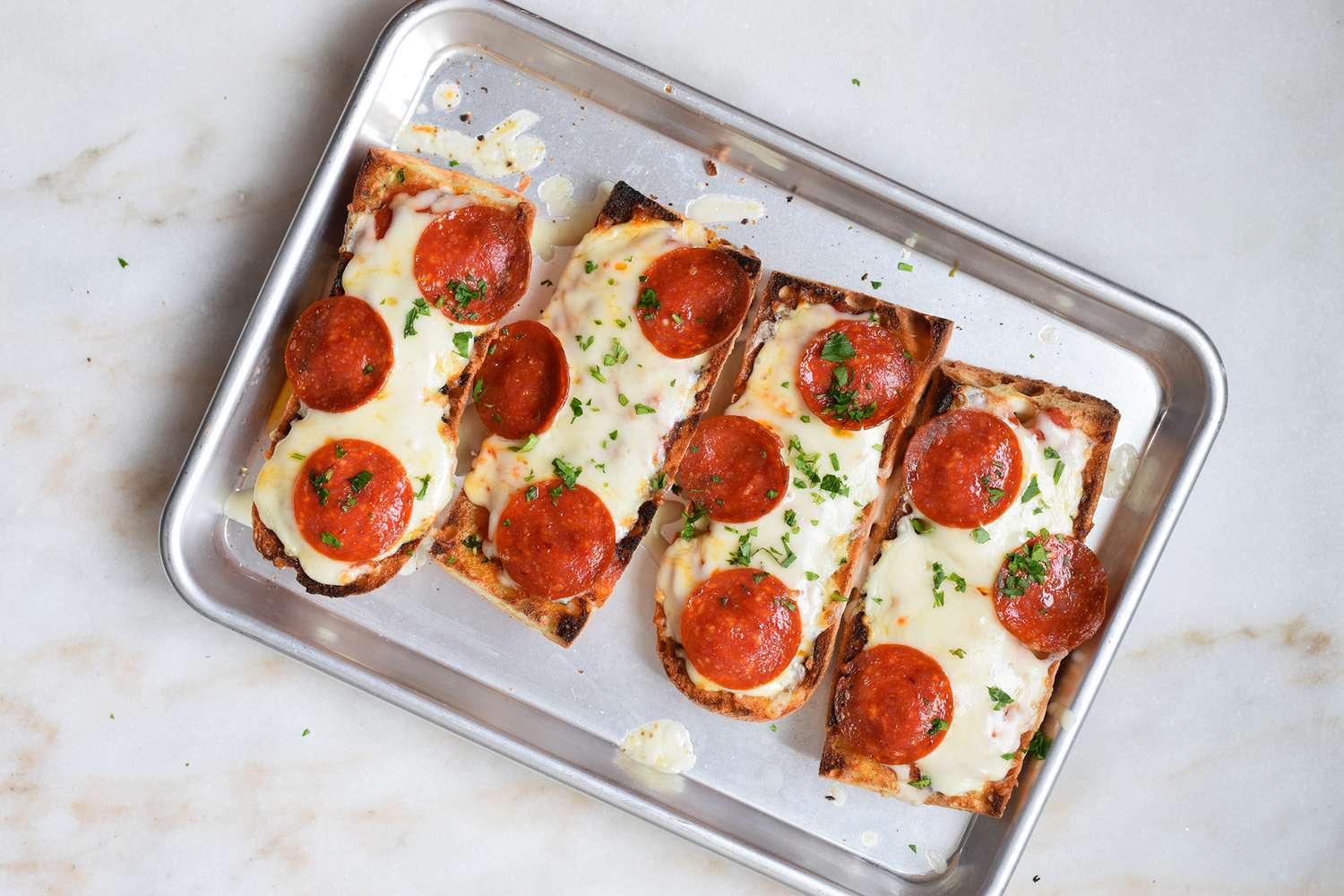 baked french bread pizza topped with chopped parsley