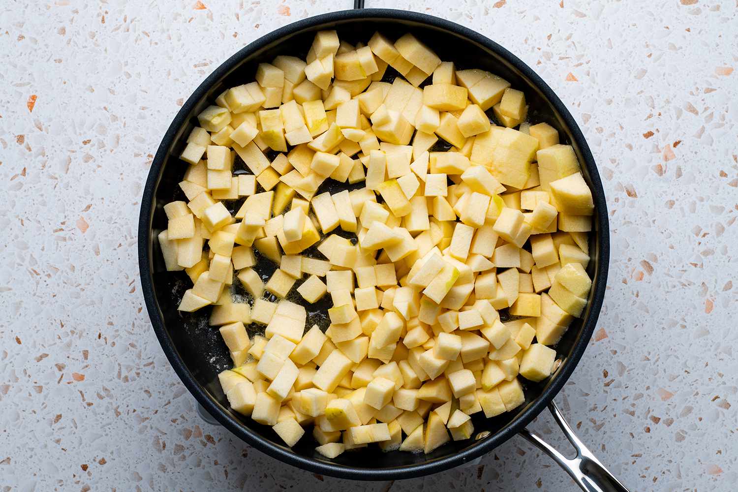 chopped apple cooking in a skillet