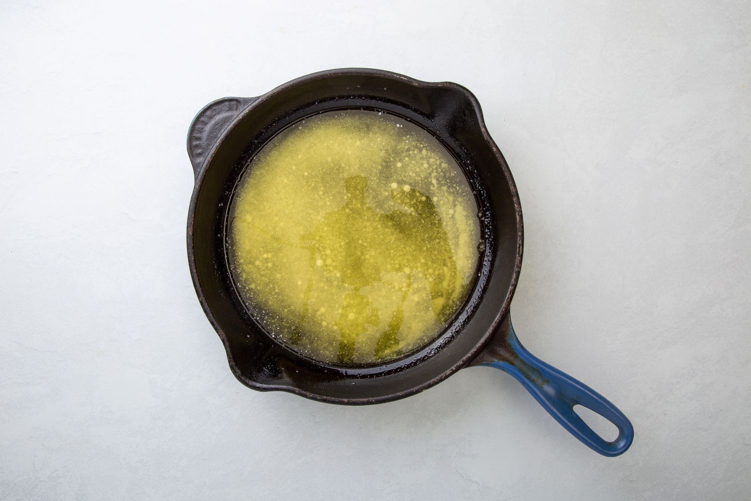 A cast iron pan with melted butter