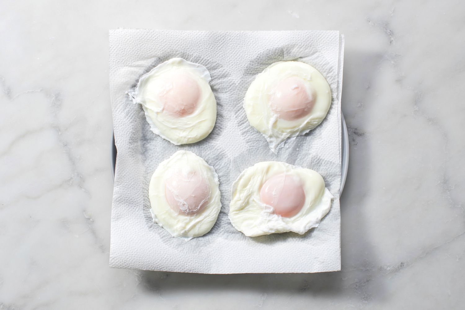 Poached eggs resting on a paper towel