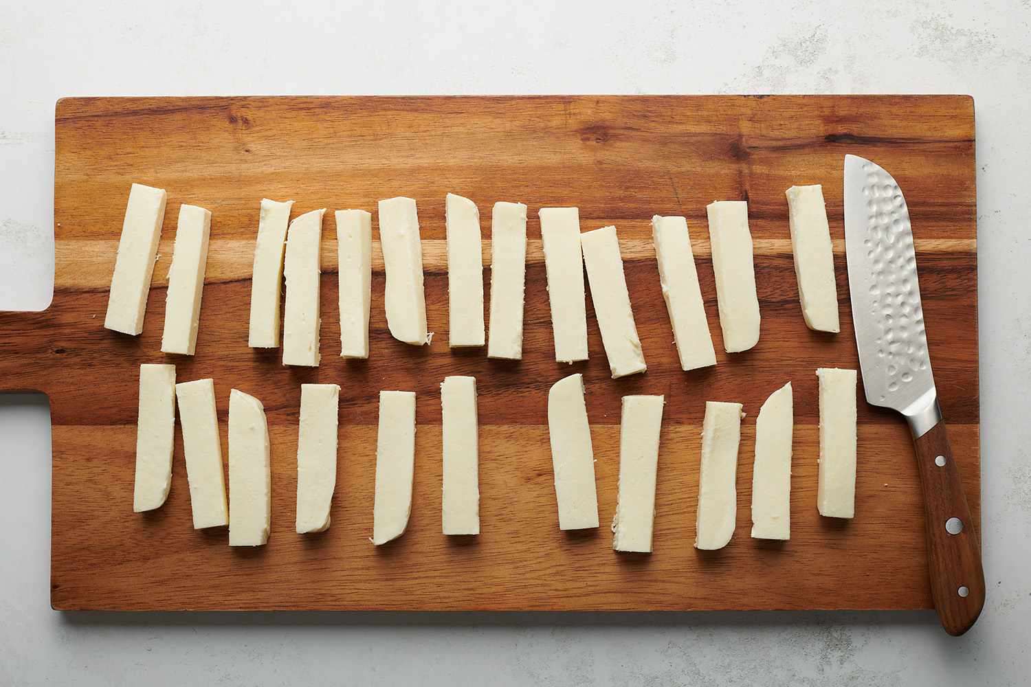 mozzarella cut in rectangles on a cutting board