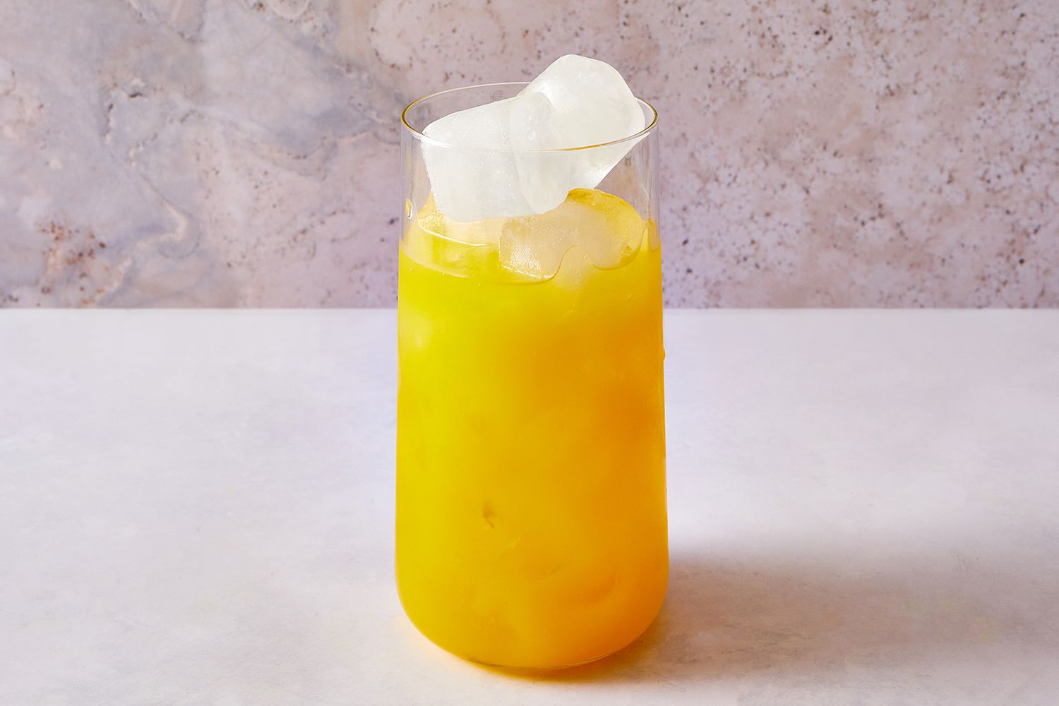 Tequila and orange juice over ice in a high ball glass