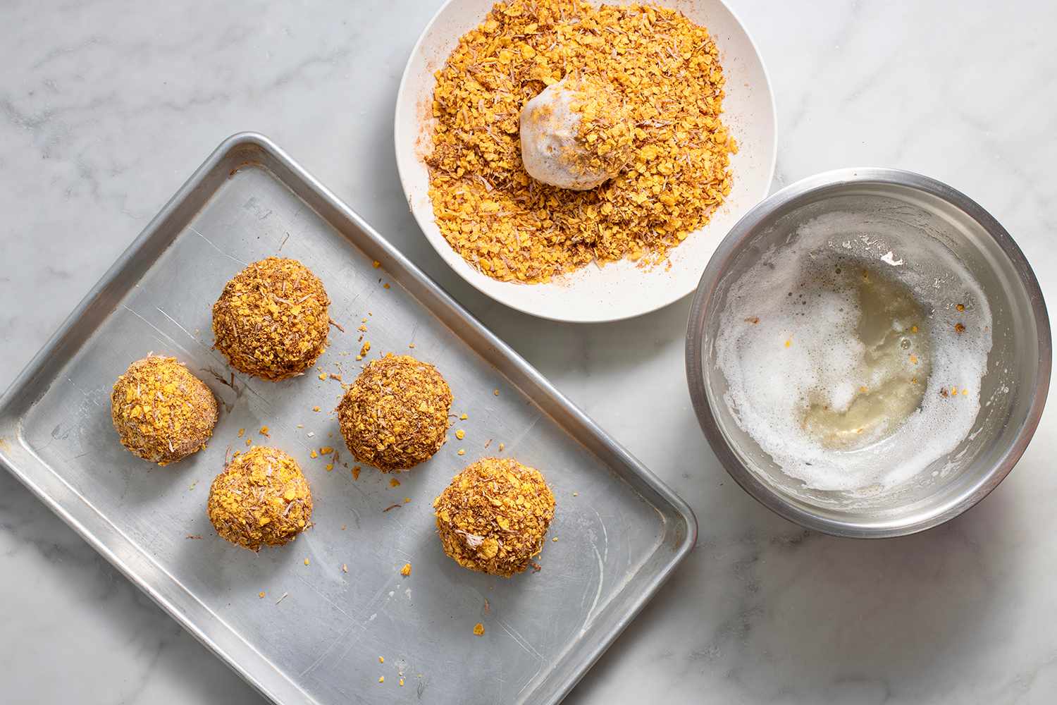 Cornflake-covered ice cream in egg whites and dipped in more cornflake mixture