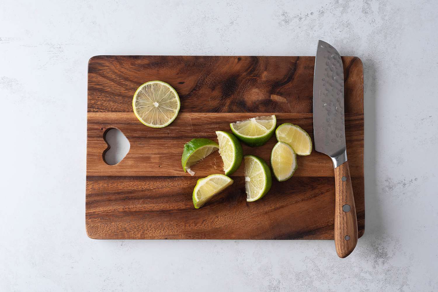 Limes sliced on a cutting board 
