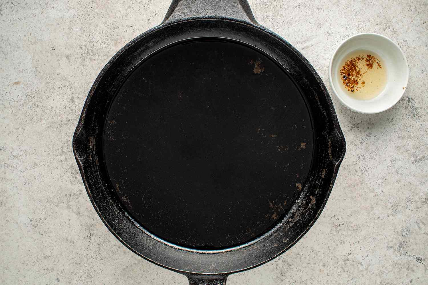 Oil in a cast iron pan, breadcrumbs removed from the oil 