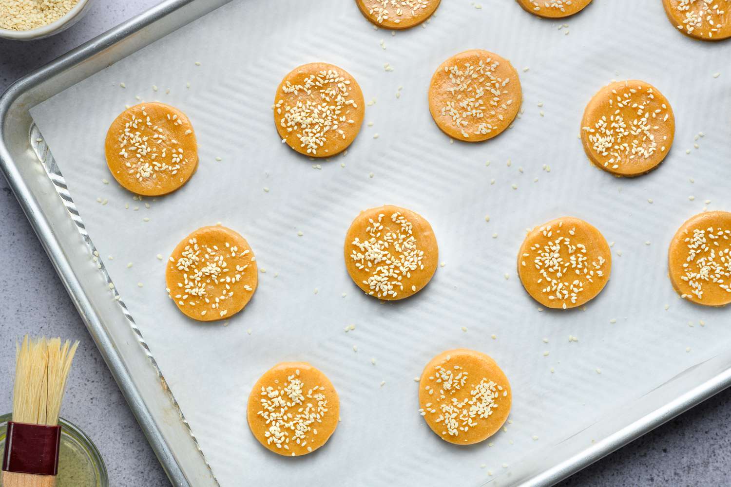 miso peanut butter cookies on sheet tray topped with sesame seeds