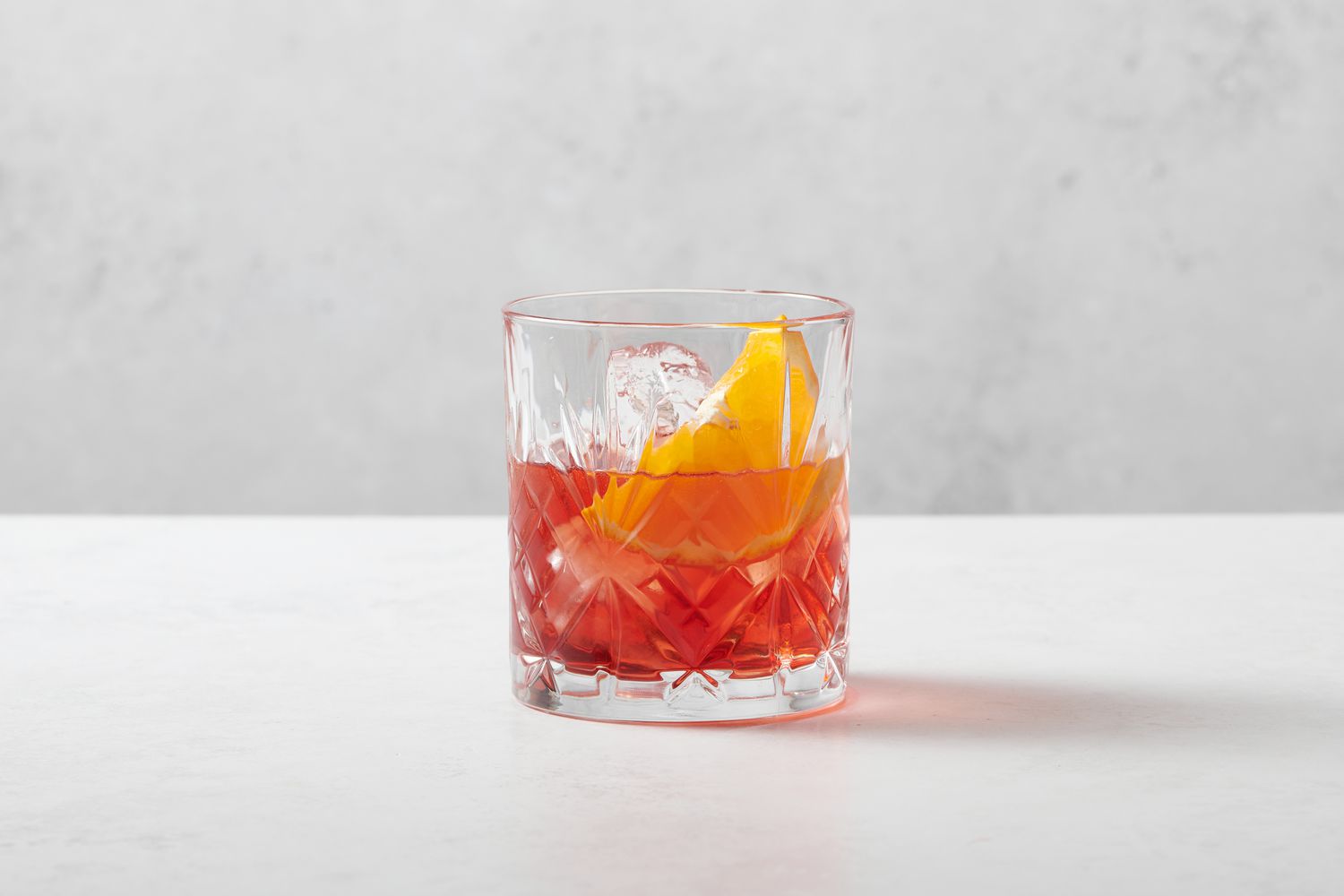 A Negroni Sbagliato cocktail garnished with an orange slice
