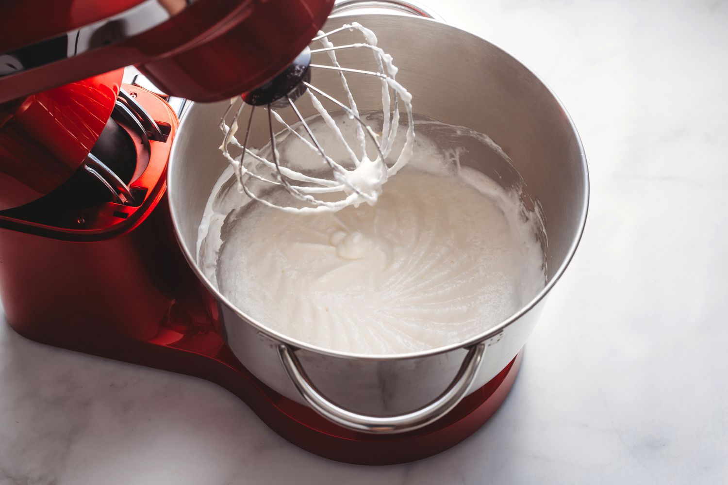 Fluffy and creamy egg white and butter mixture in the stand mixer 