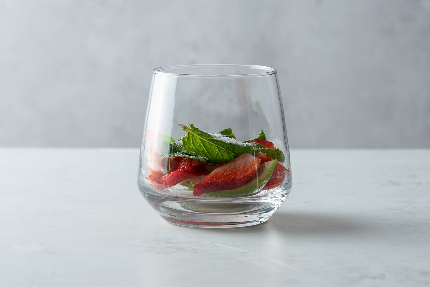 Strawberries, lime and mint in a glass 