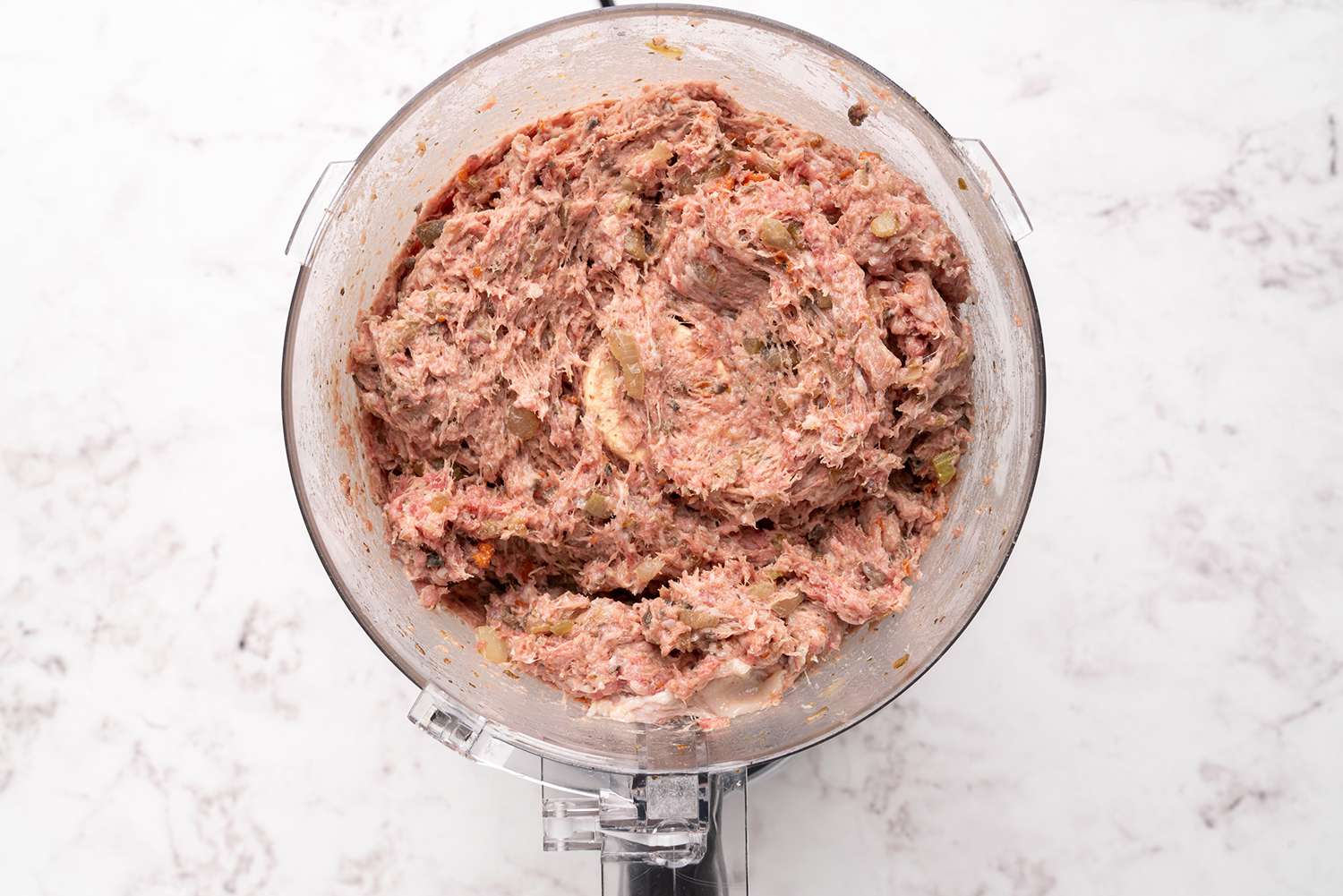 Bacon, beef, and pork with vegetables in a food processor 