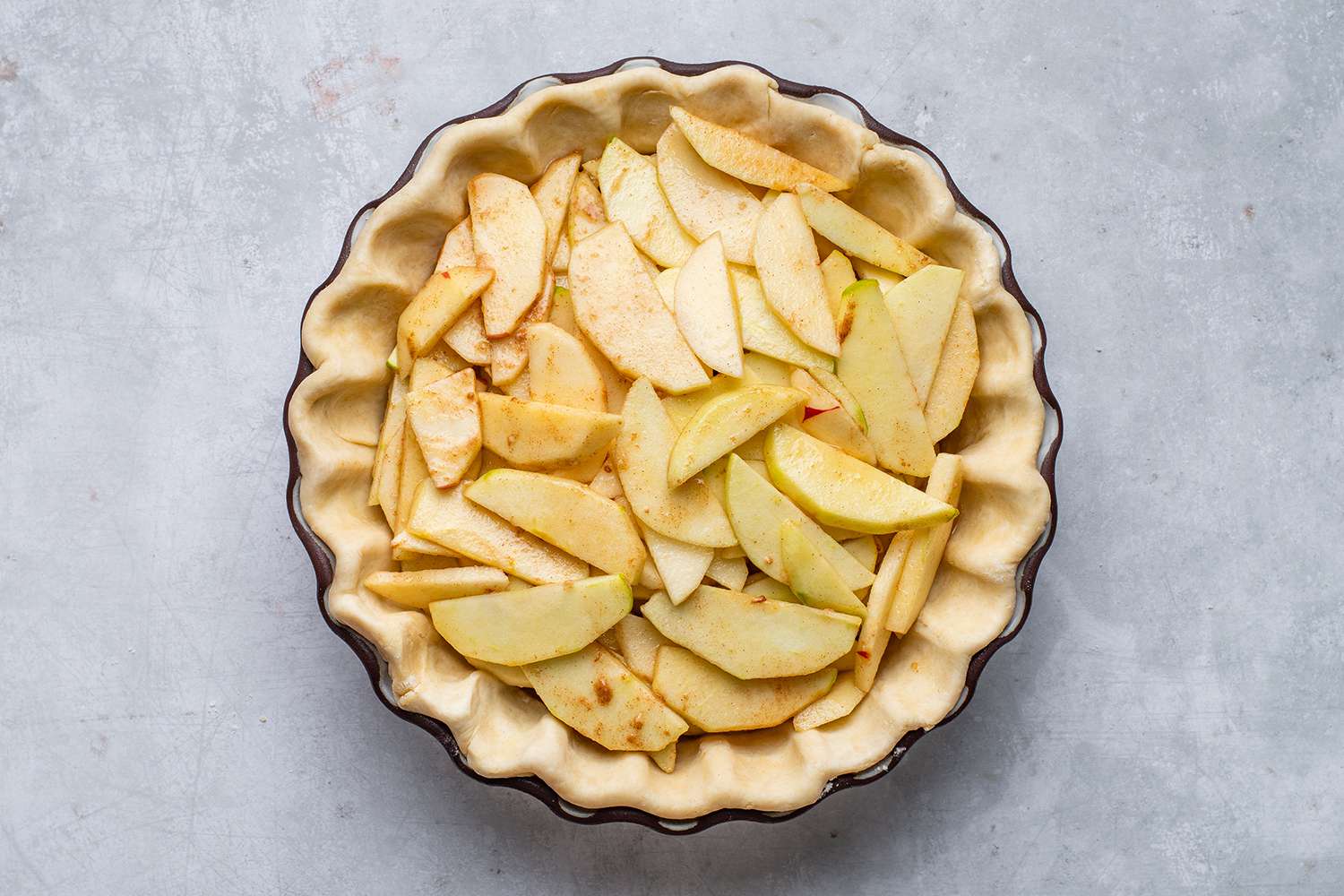 sliced apples in pie pan