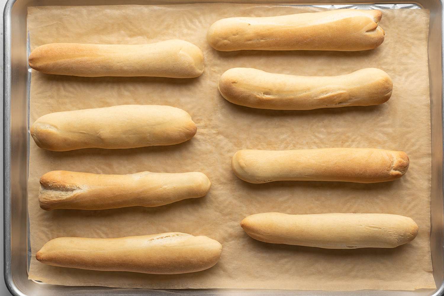 Baked breadsticks on a parchment paper lined baking sheet 