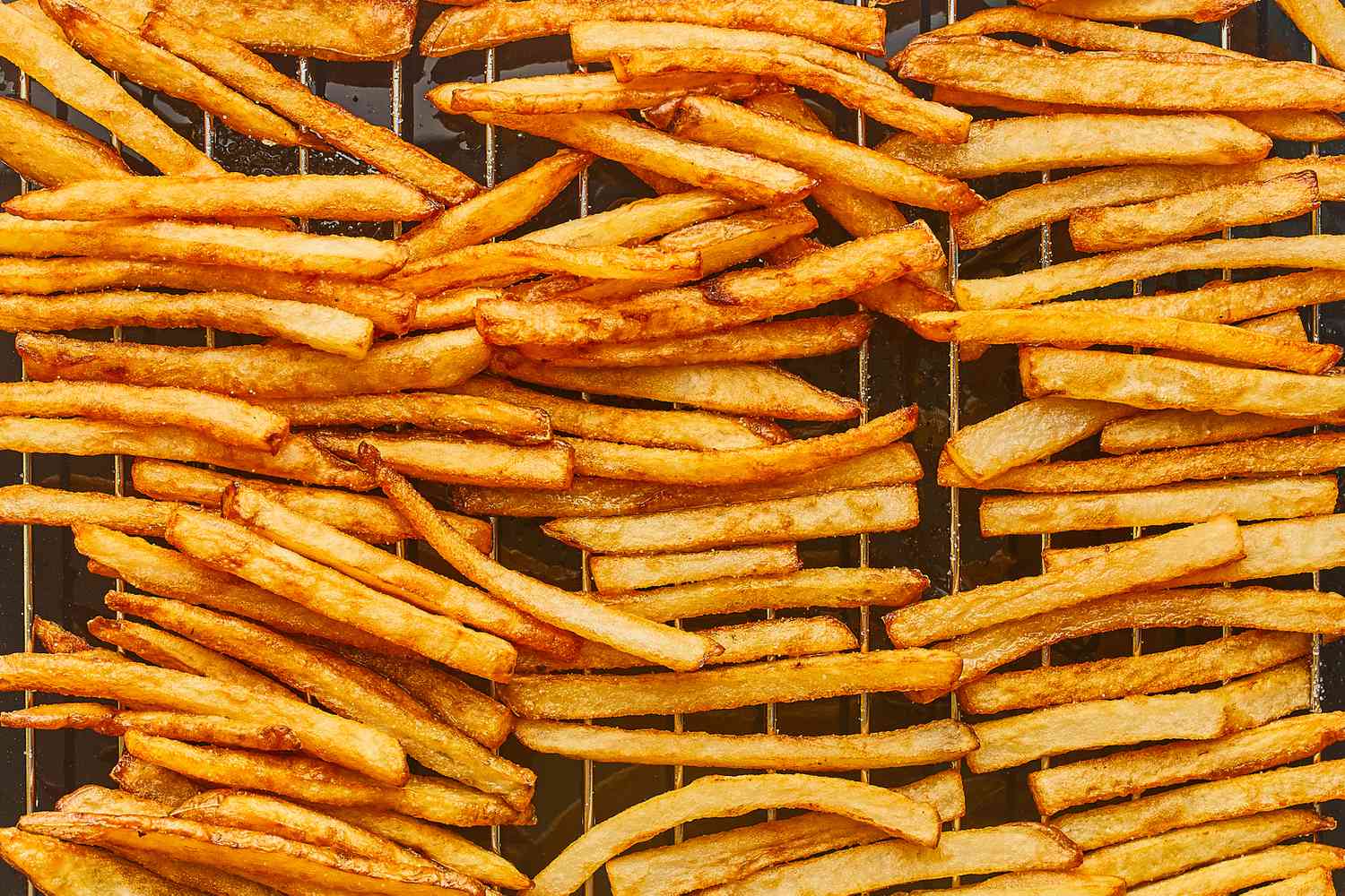 French fries draining on a rack