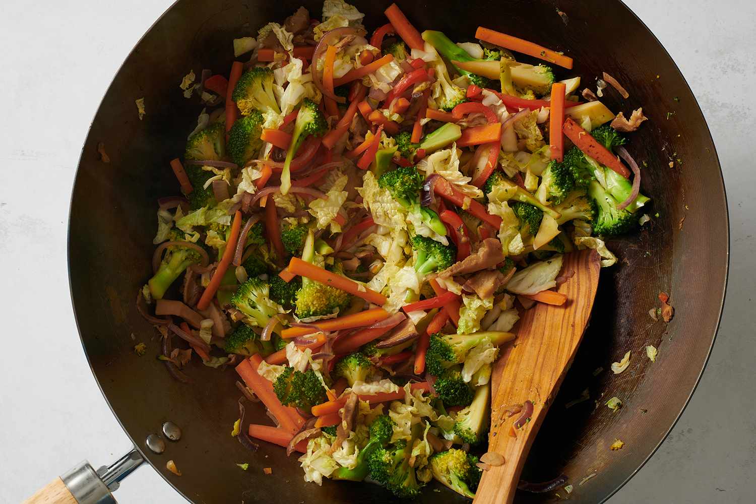 Mushrooms and cabbage added to the wok