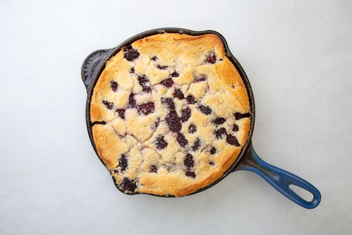 A full baked blackberry cobbler in a cast iron pan