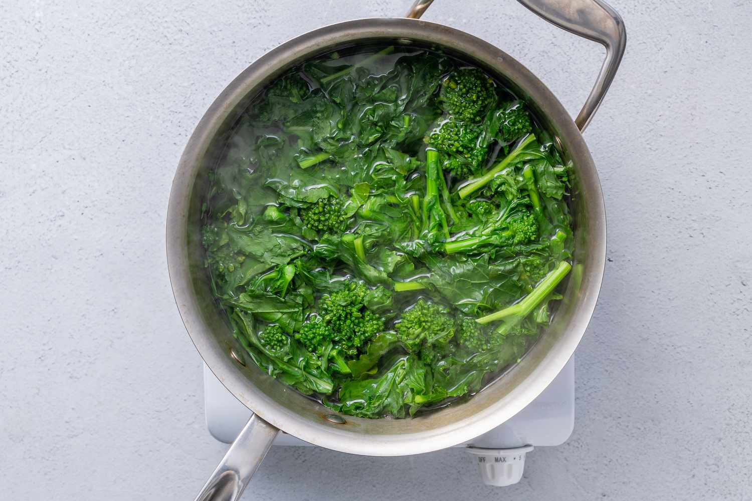 Broccoli rabe cooking in a pot of boiling water