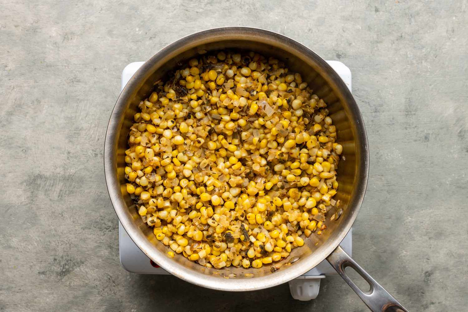 Corn mixture cooking in a pot on the burner 