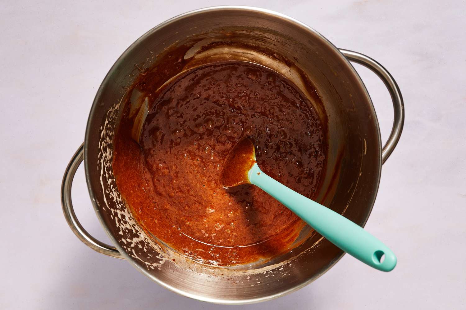 melted chocolate being folded in to egg mixture with spatula