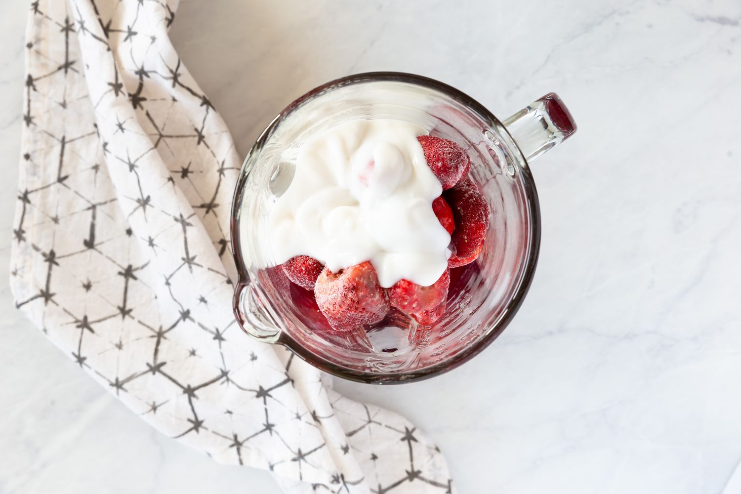 Strawberry smoothie ingredients in a blender