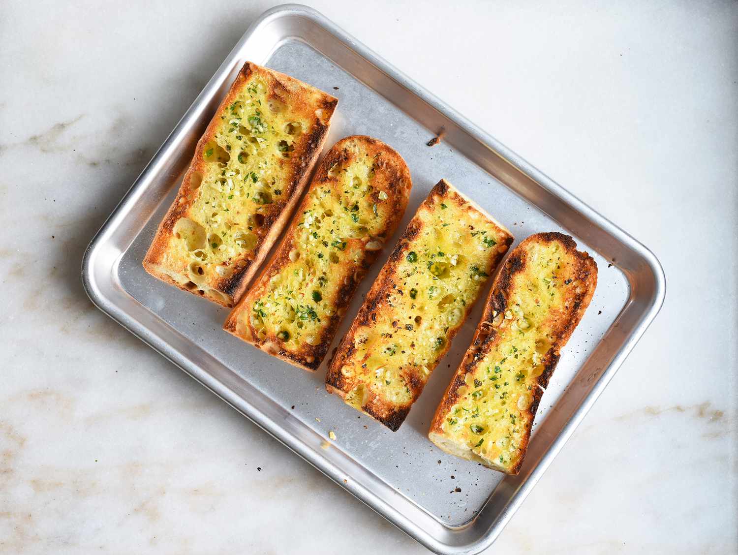toasted garlic bread on a sheet pan