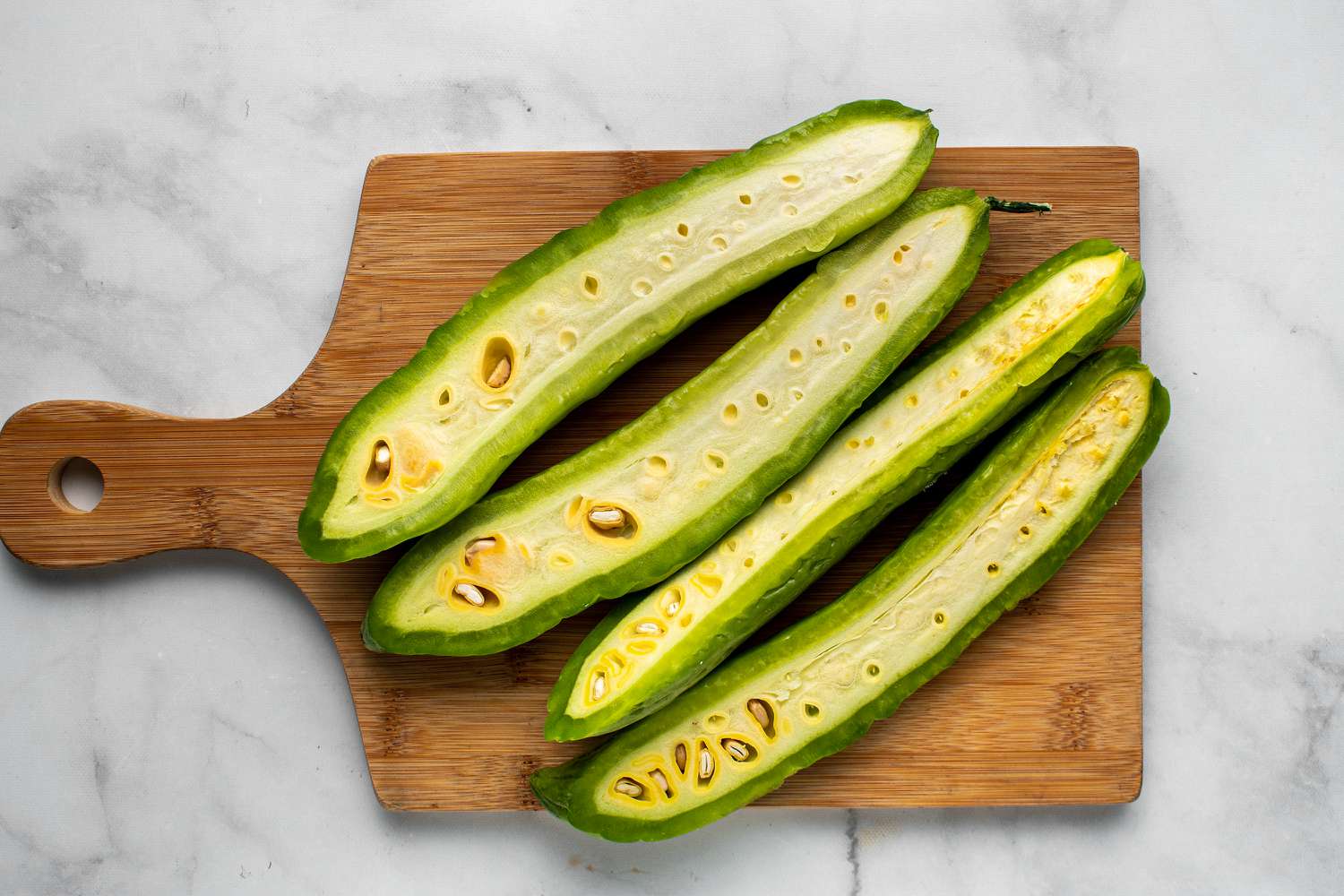 Cut the ends off the bitter melon and cut in half lengthwise