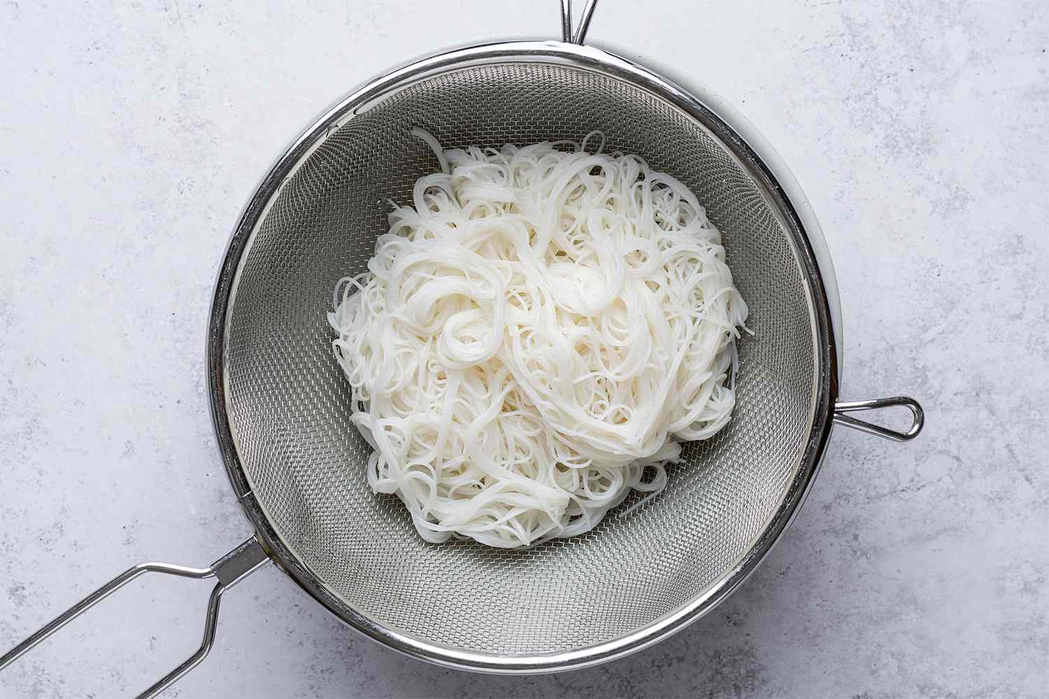 Rice noodles in a strainer 