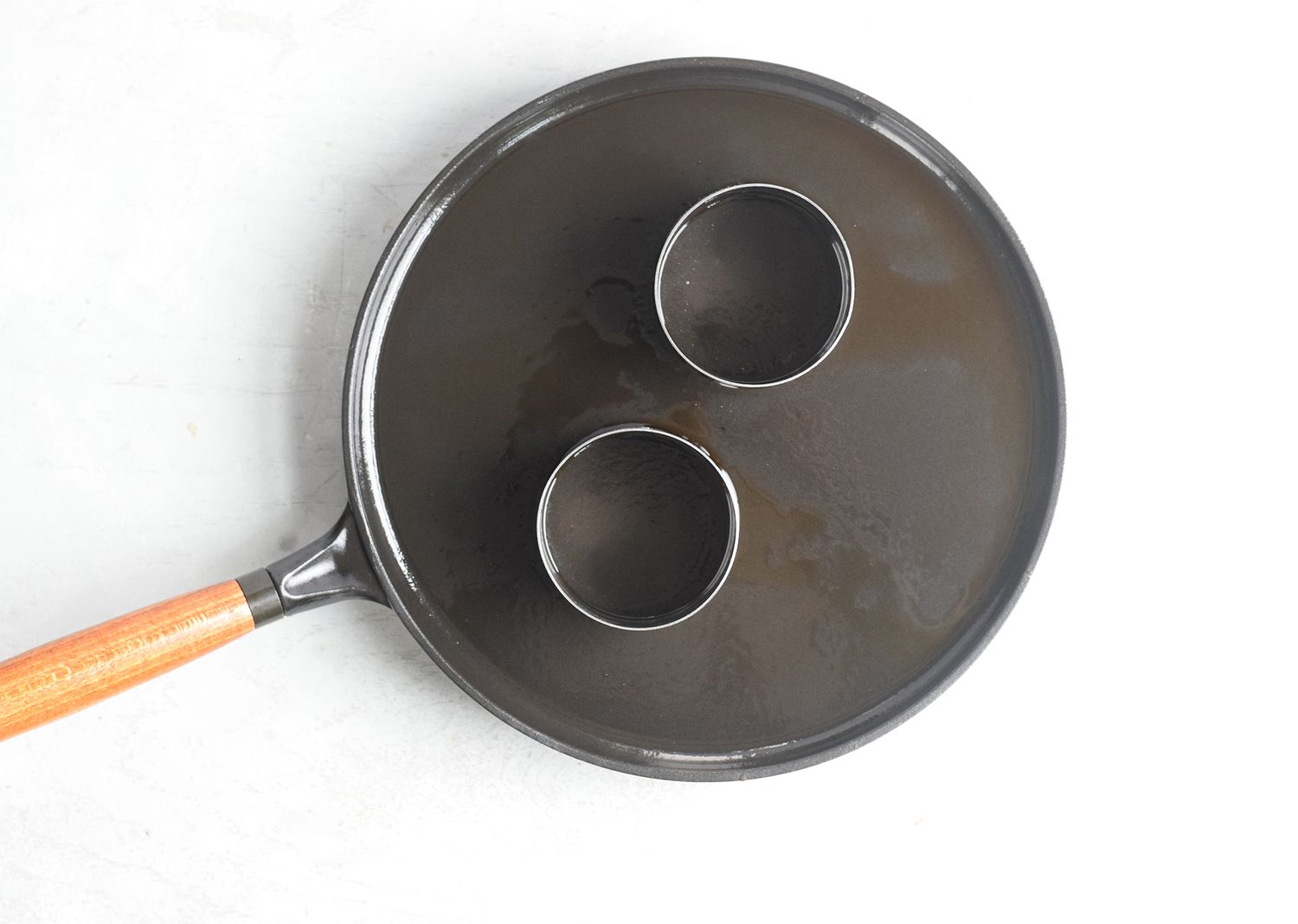 Skillet with pastry molds on top