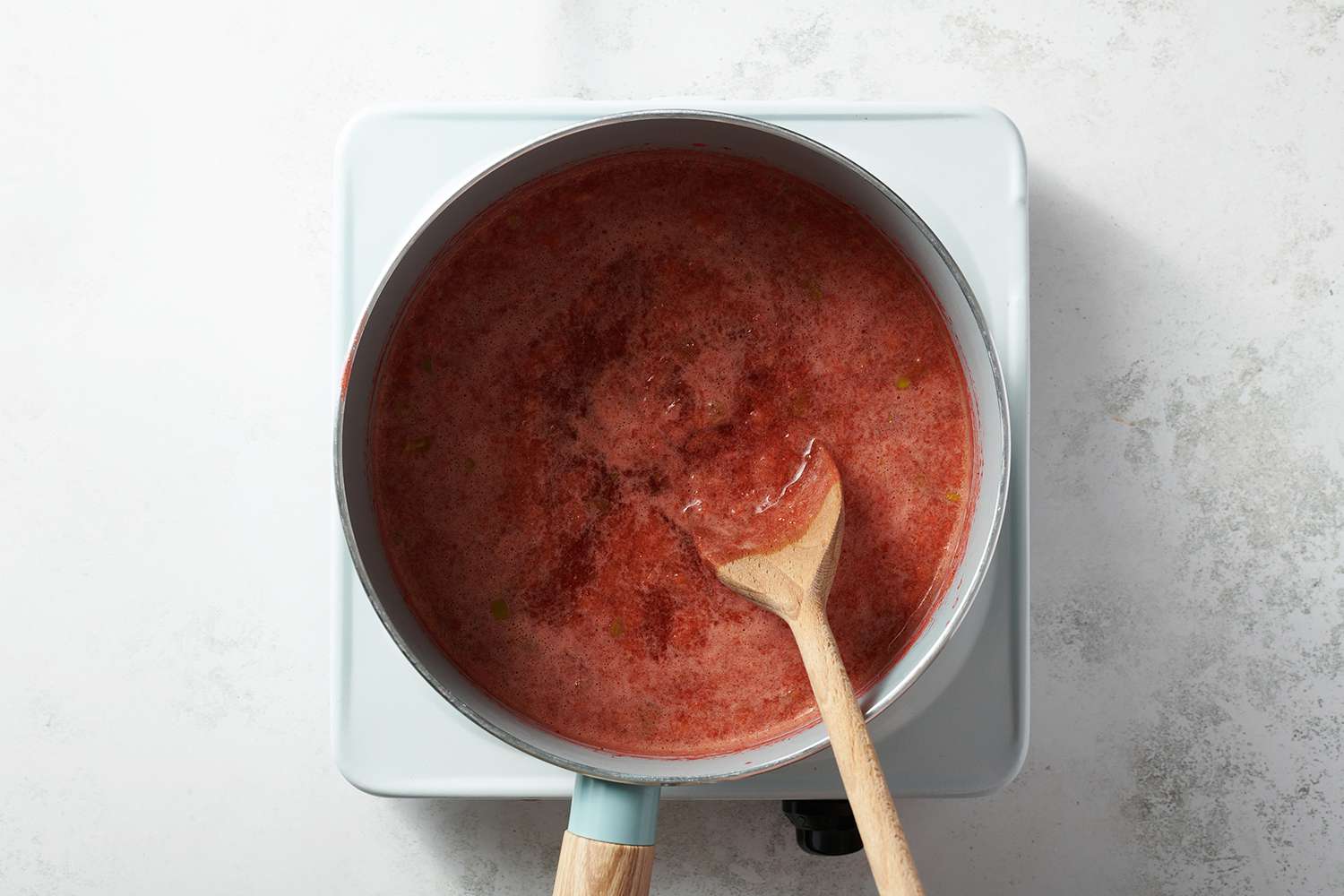 strawberry puree cooking in a sauce pan