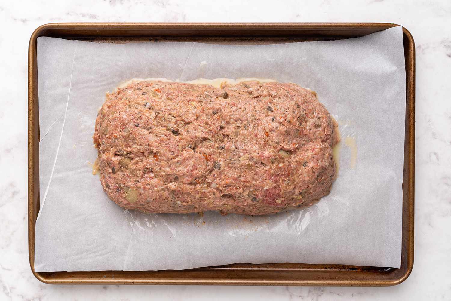 Meat loaf on a parchment paper lined baking sheet 