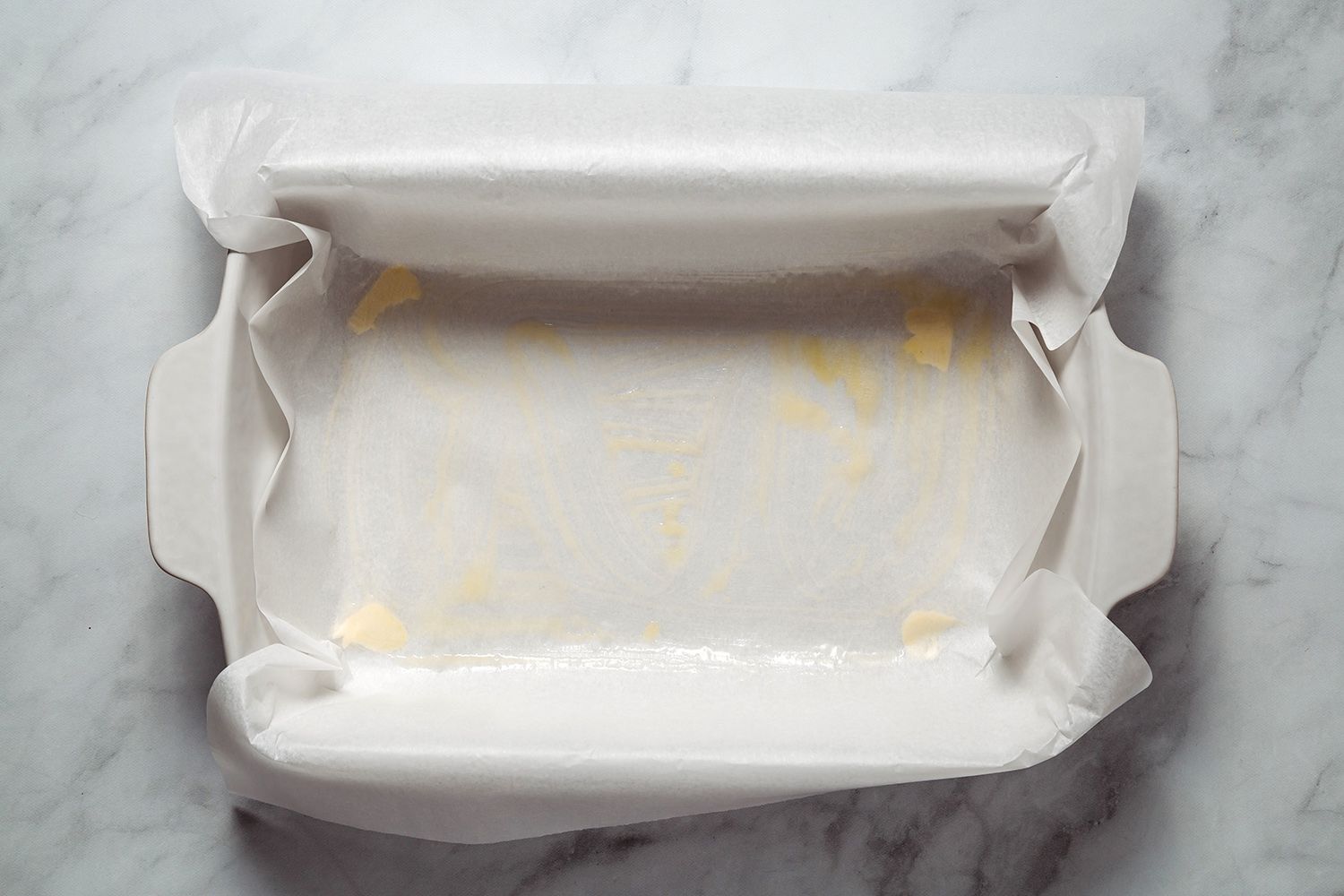 Greased and parchment paper lined baking dish 