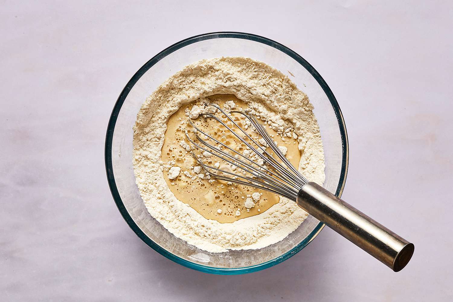 pancake batter in a bowl with a whisk 