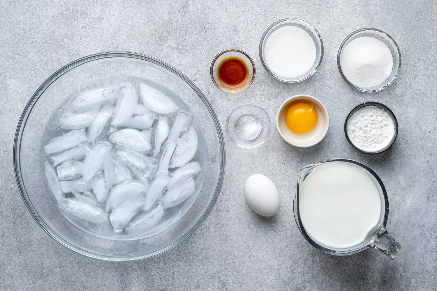 Ingredients to make pastry cream and a bowl with ice water