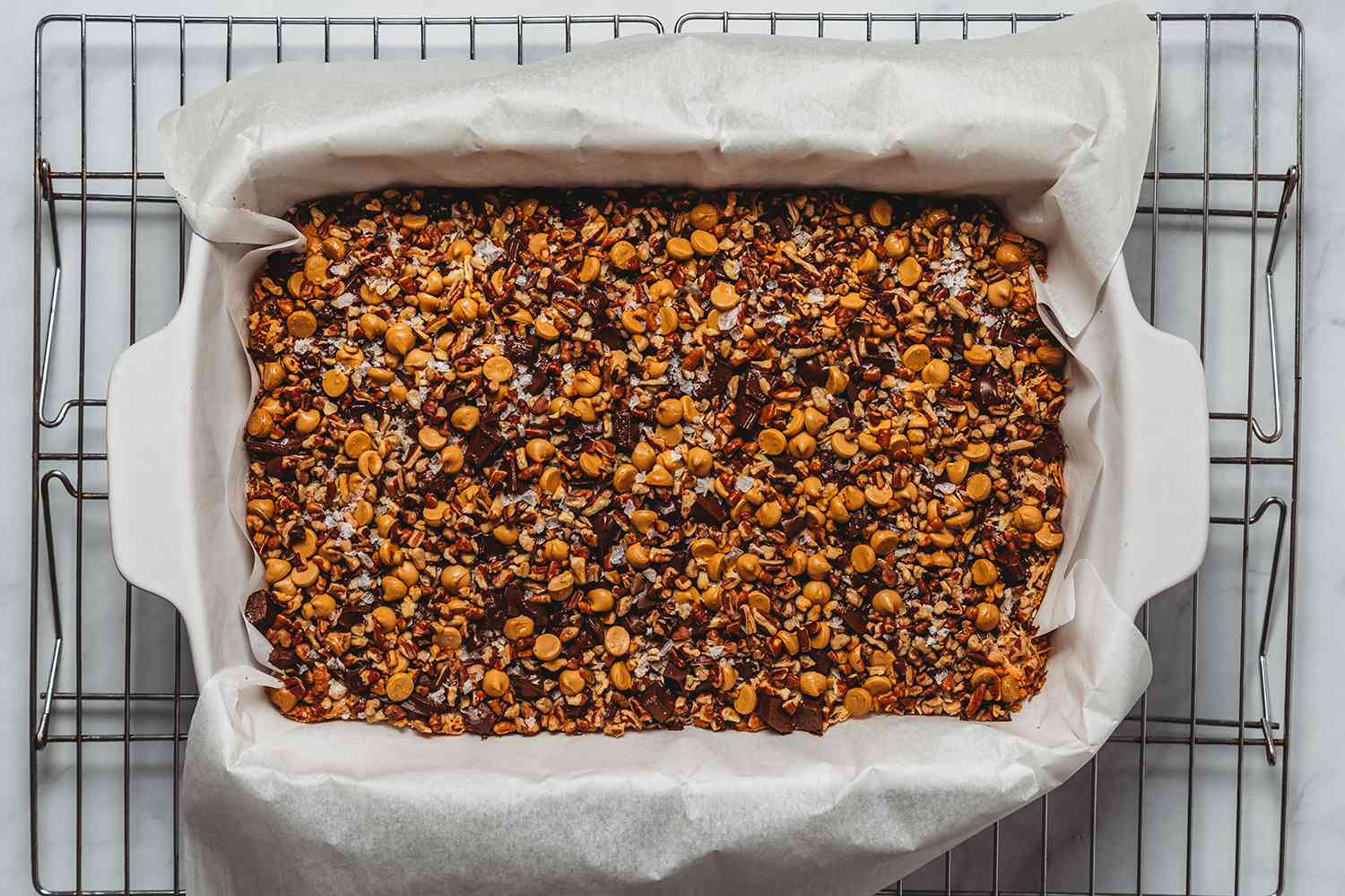 Baked Magic Cookie Bars in a prepared baking dish, on a cooling rack 