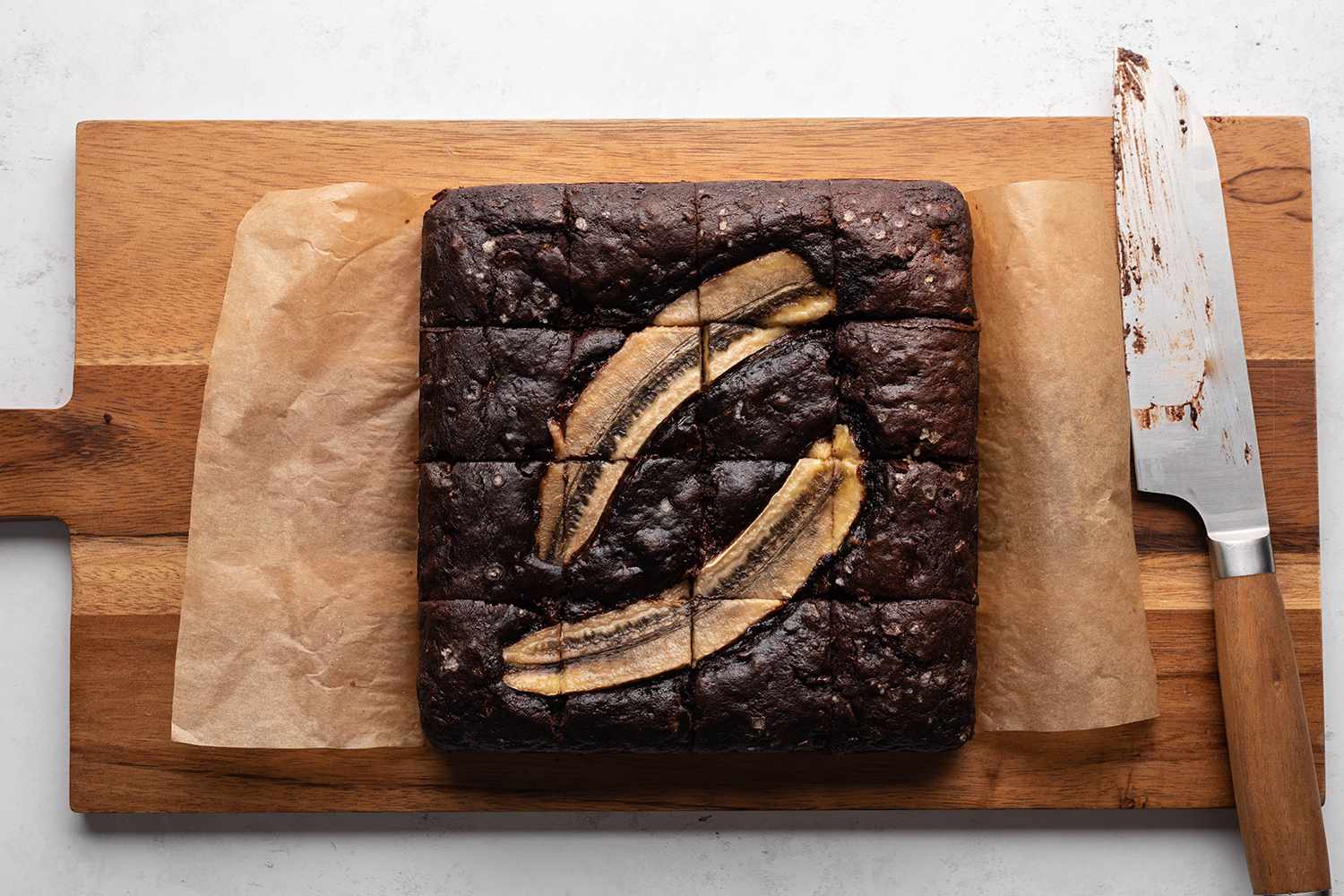 Banana Bread Brownies on a cutting board with a knife 