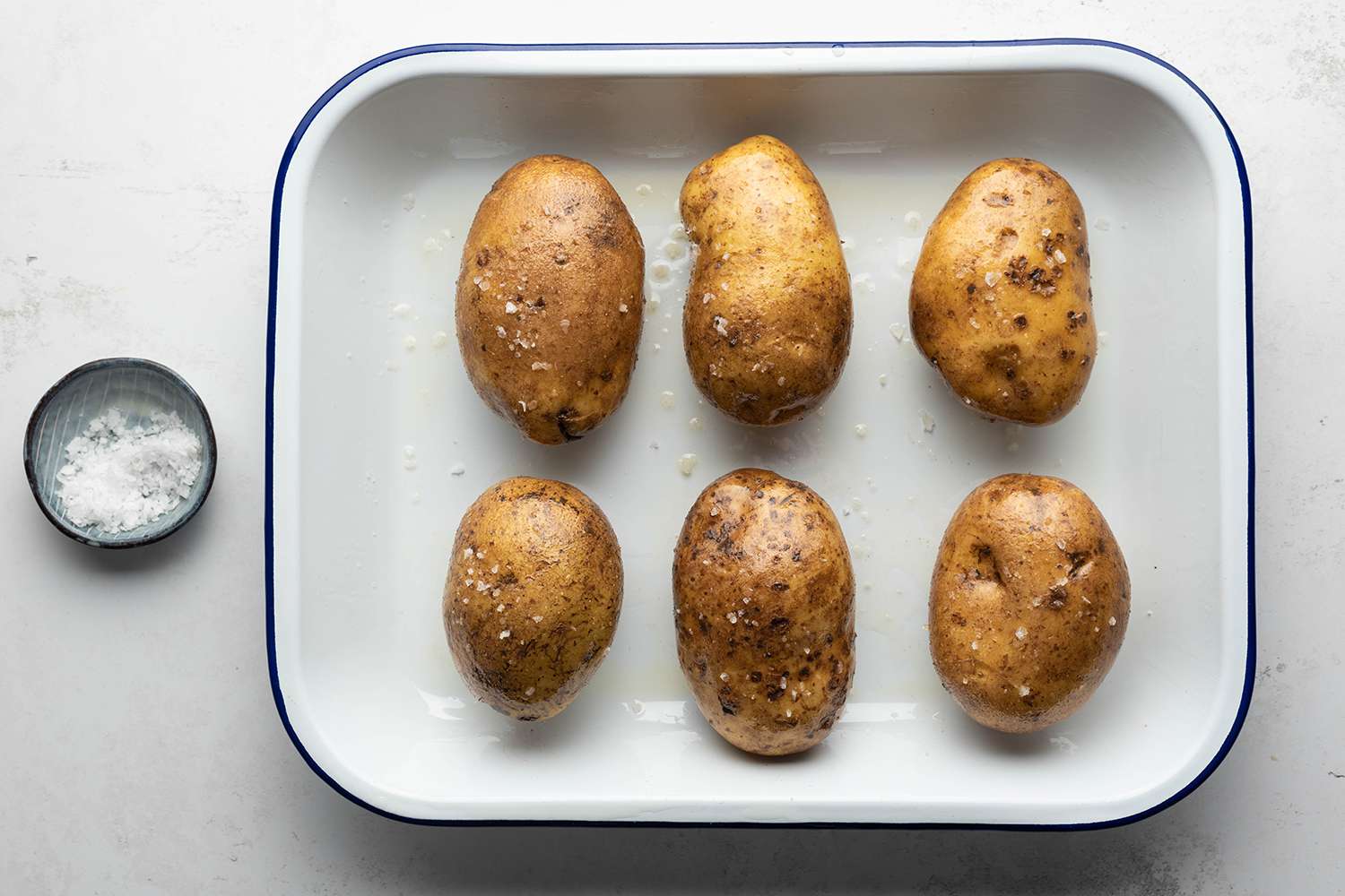 Potatoes in a baking dish with salt 