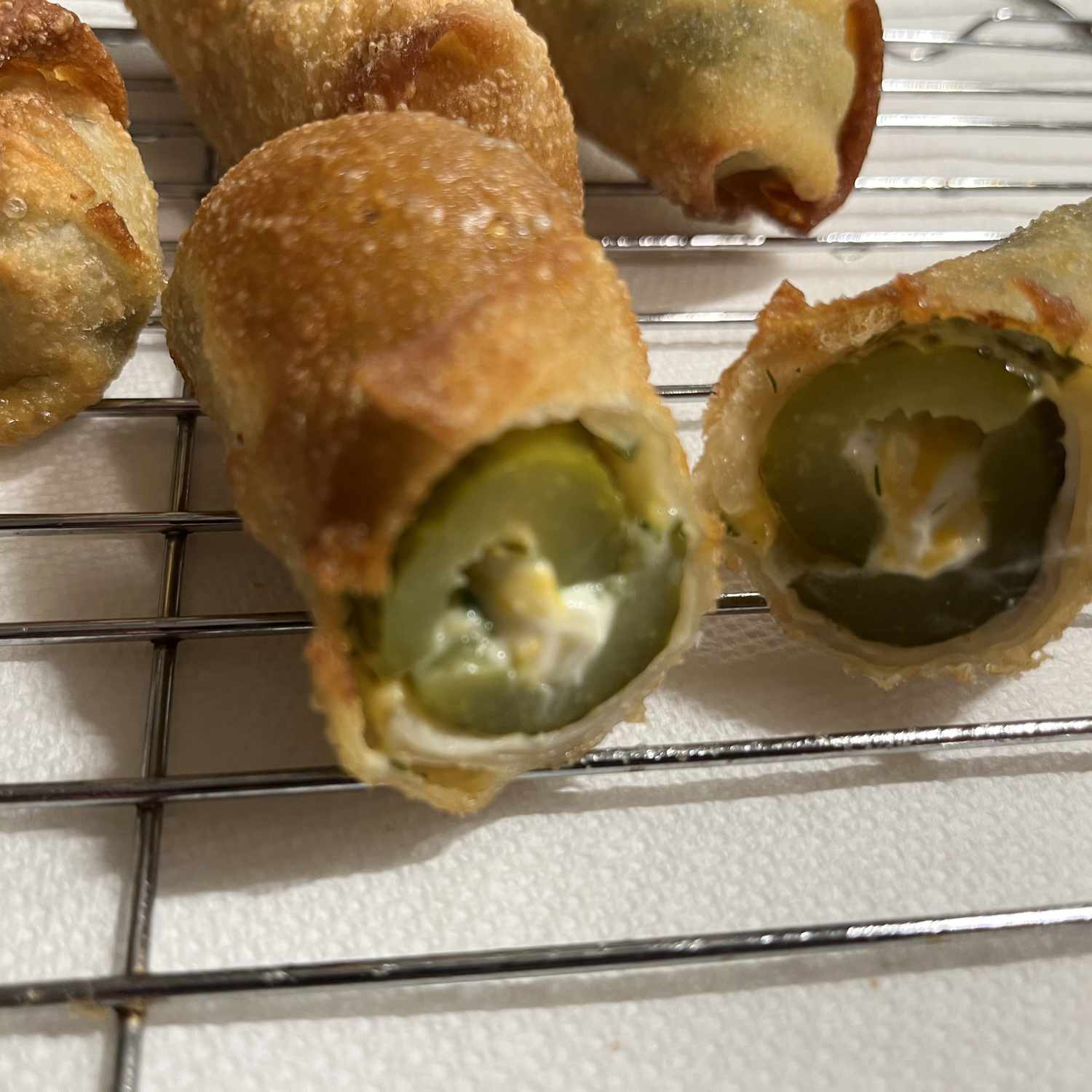 Pickles stuffed with cheese and wrapped in egg roll wrappers and fried