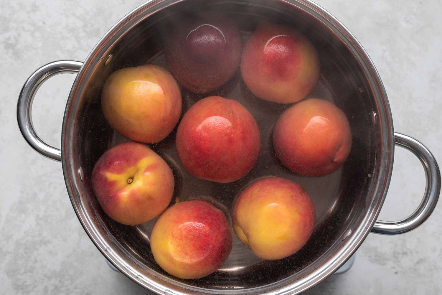 Peaches in a pot with water