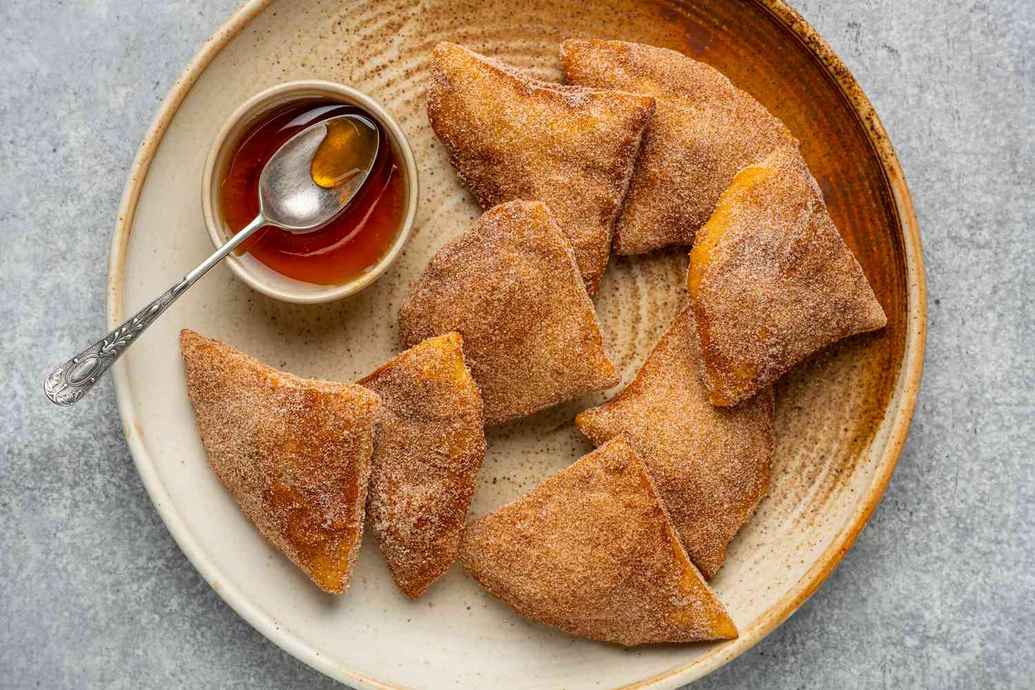 A plate of sopapillas served with honey