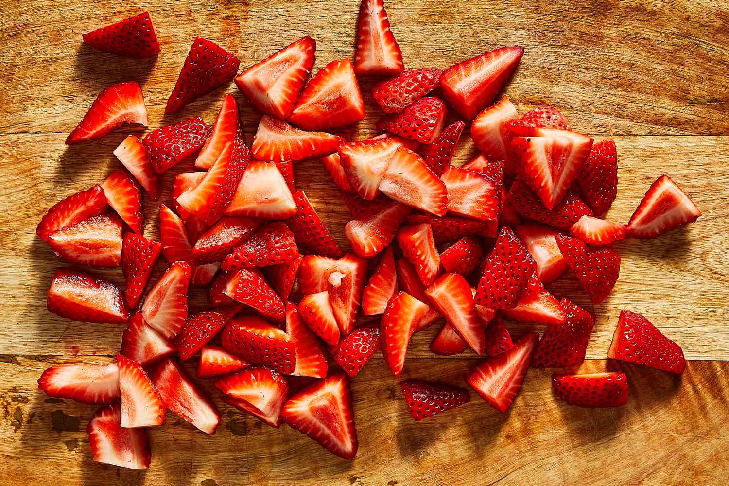 Slices of strawberries on a cutting board