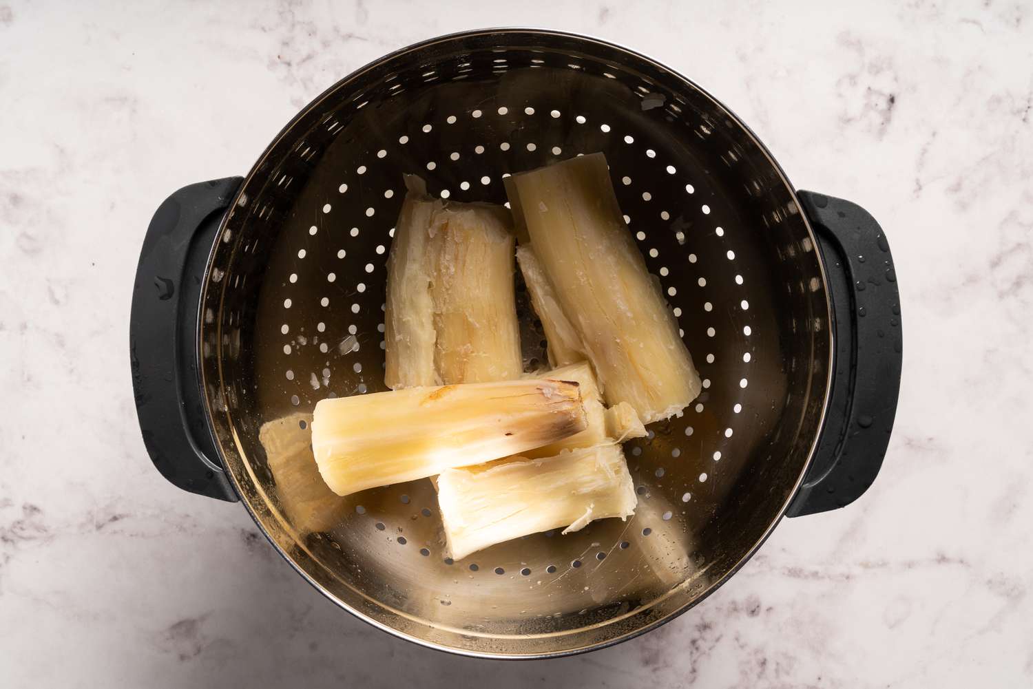 Drain and cooked cassava resting in a colander 