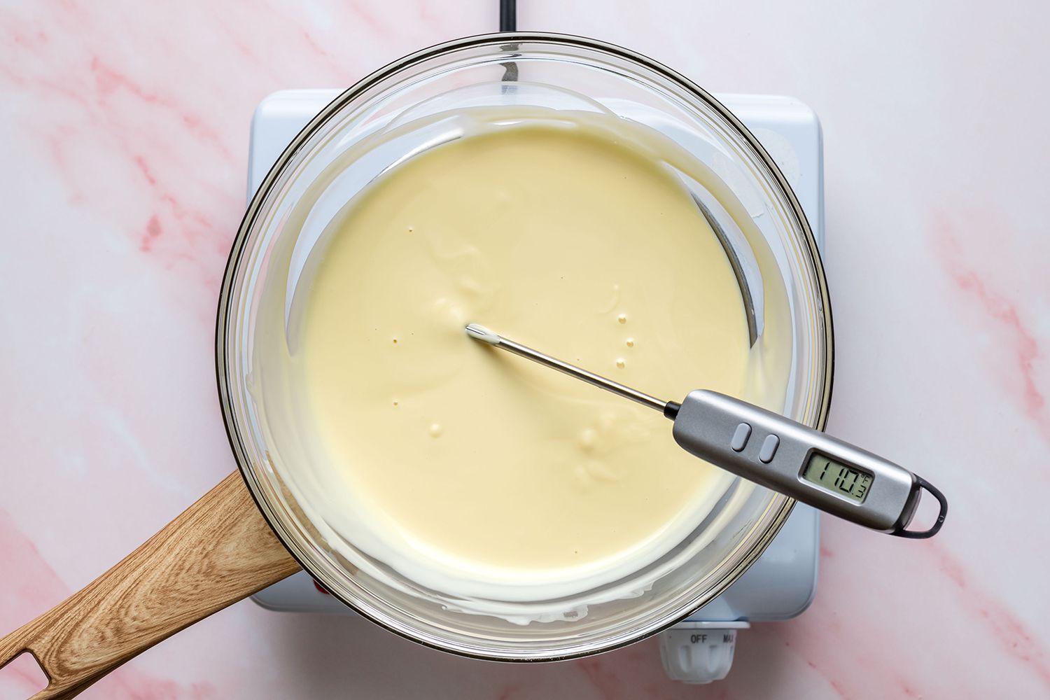 thermometer in a bowl of melted white chocolate