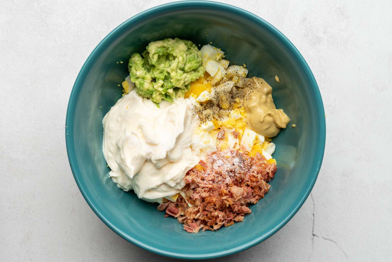 egg salad ingredients in a bowl 